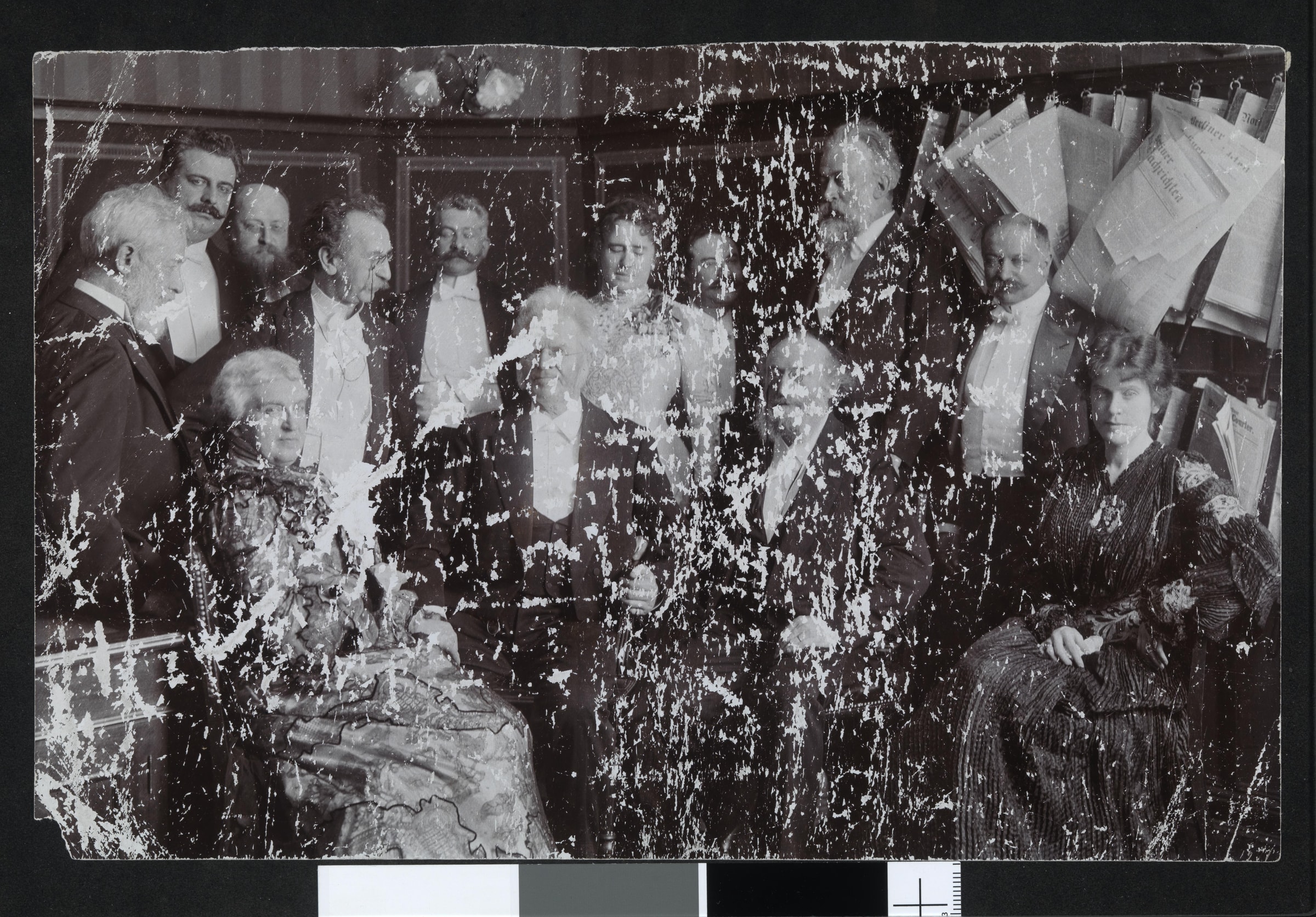 A group portrait with severe flaking across the emulsion, before restoration